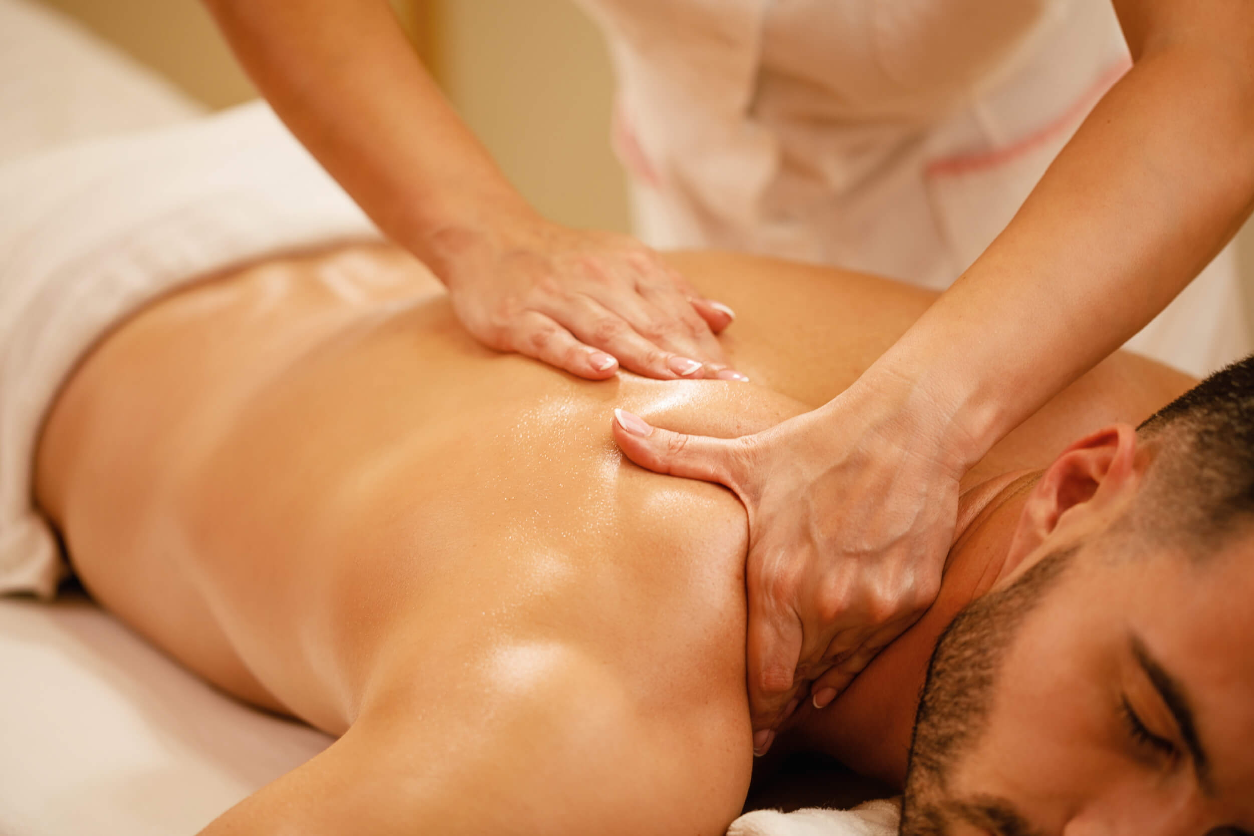 Closeup man having back massage spa treatment wellness center